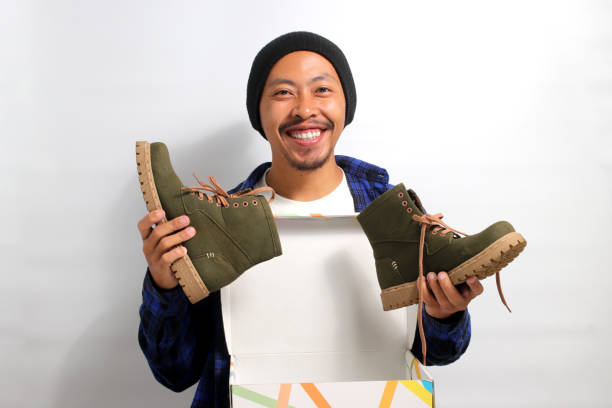 istock Asian man holding new shoes 1863080998