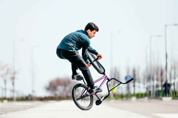 istock Young man performing tricks with a flatland bmx bike 1863087642