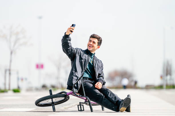 istock Young man taking a photo with smartphone with his bicycle 1863088163