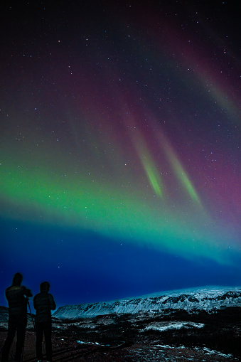 Northern lights over Iceland with observers