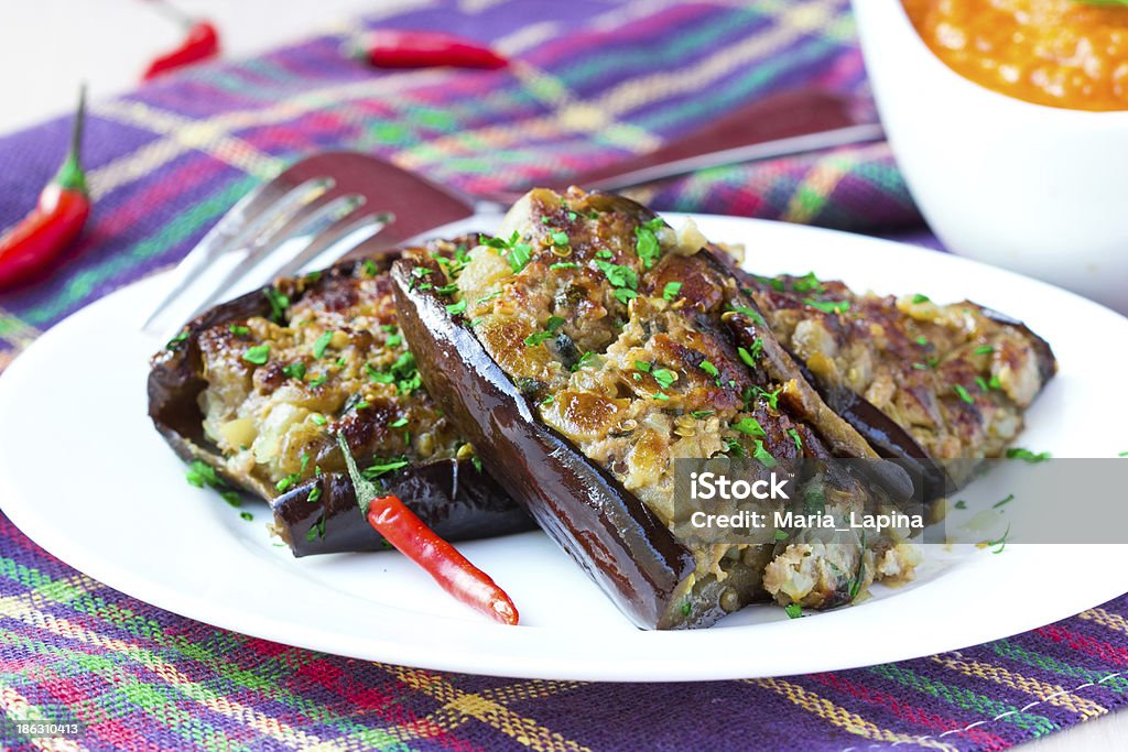 Eggplants stuffed with meat and vegetables, traditional Italian Eggplants stuffed with meat and vegetables, traditional Italian dish on plate with sauce Appetizer Stock Photo