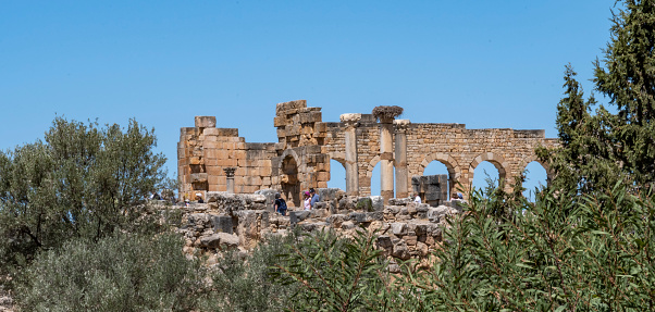 Volubilis, Meknes, Morocco - may 15, 2023: remains of a palace with arches and columns in the city of Volubilis, up to the 3rd century AD Roman outpost in Africa.