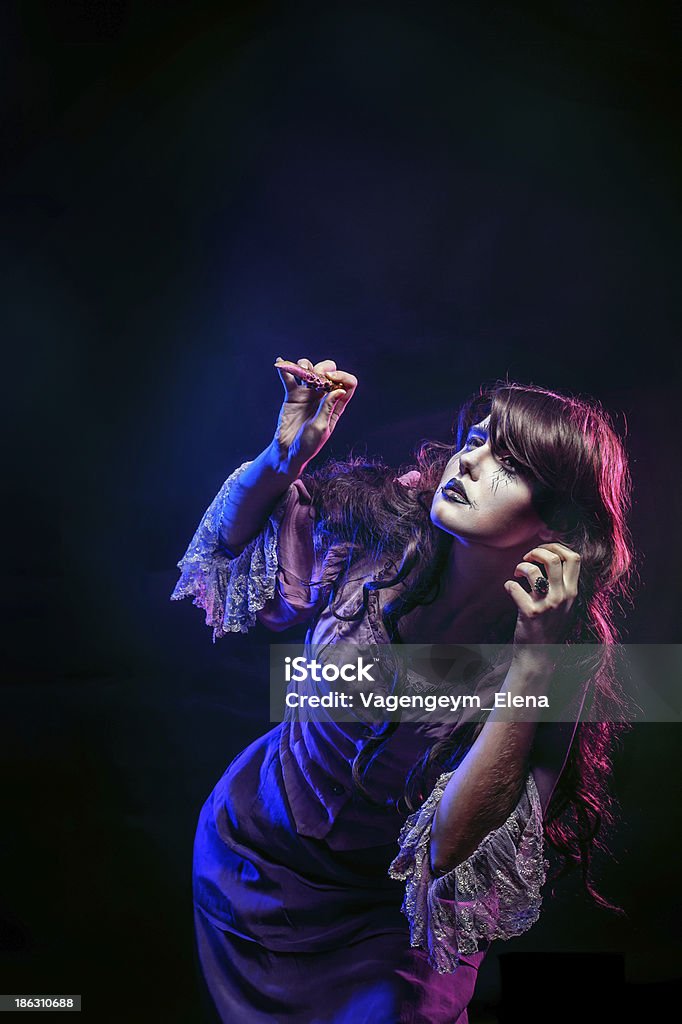 Witch and the magic wand Girl in the image of a witch with a magic wand shot in studio Adult Stock Photo