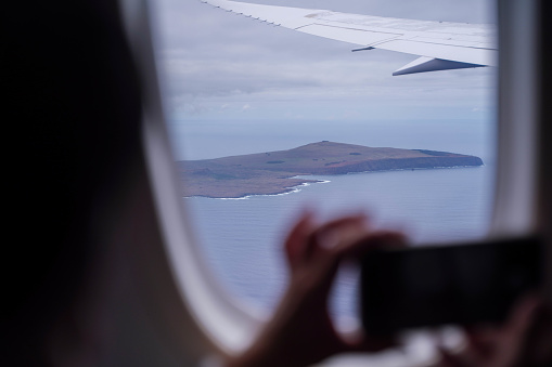 Photographing Easter Island, Chile, with a mobile phone from an airplane window