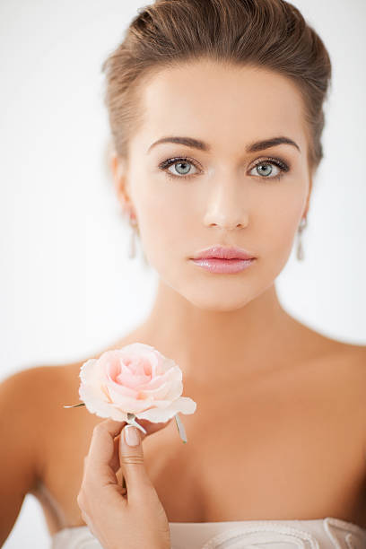 istock young woman with rose flower 186312270