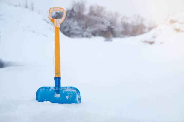 istock Shovel sticking out in a large snowdrift, close-up 1863126867