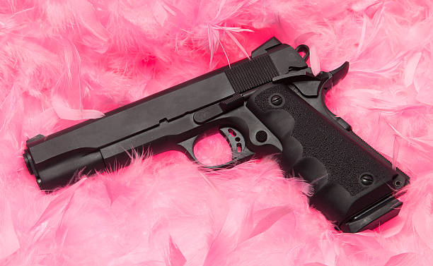 Pink Feathers with Handgun stock photo