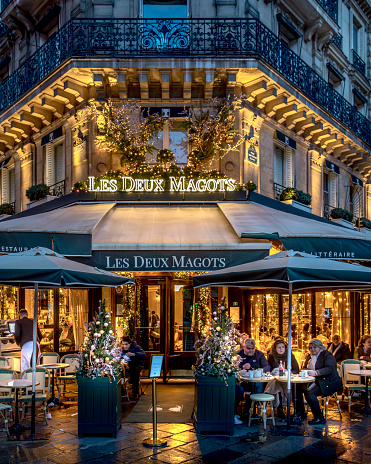 Paris, France - December 10, 2023: Les Deux Magots restaurant in Saint Germain des Prés during Christmas period in Paris.