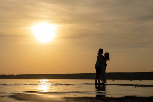 istock A romantic couple embracing at the beach on sunset 1863142539