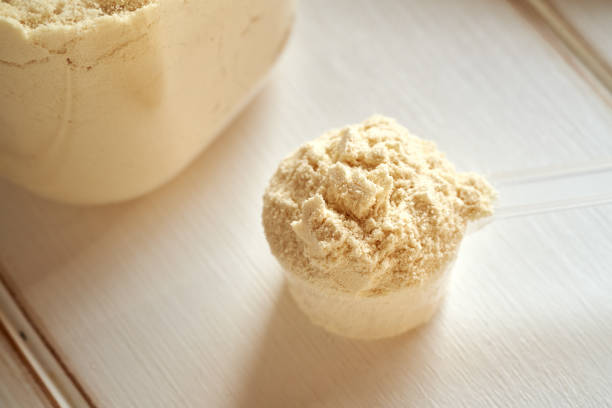 istock Whey protein powder in a measuring scoop on a white table 1863142541