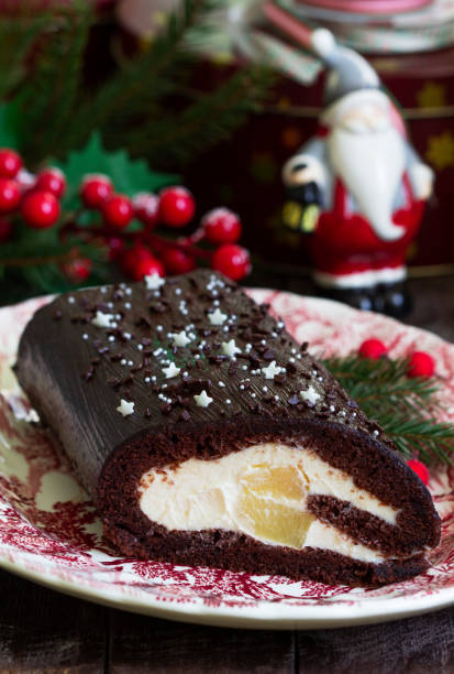 istock Chocolate roll stuffed with butter cream and pineapple on a Christmas background. Rustic style. 1863169686