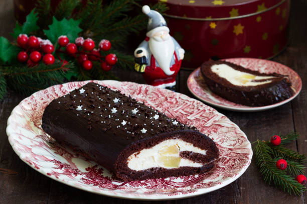 istock Chocolate roll stuffed with butter cream and pineapple on a Christmas background. Rustic style. 1863169688