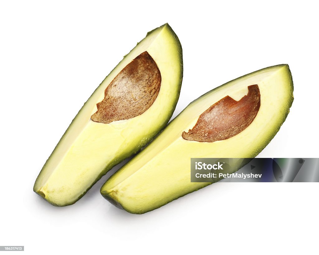 avocado slices two avocado slices isolated on white background Avocado Stock Photo