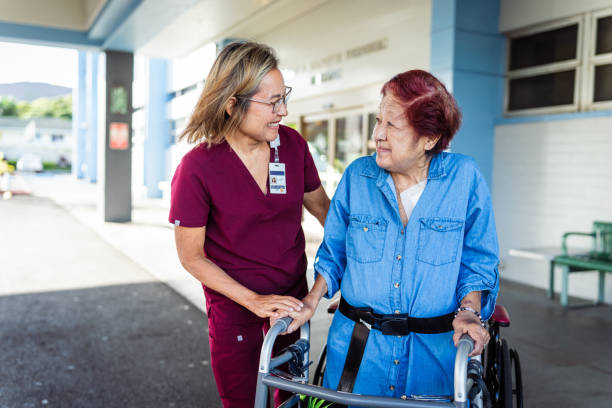 istock Caring occupational therapist helping elderly patient walk with transfer gait belt 1863176980