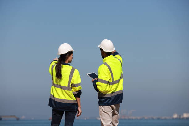 two projects engineer discussion at the coastline near the refinery