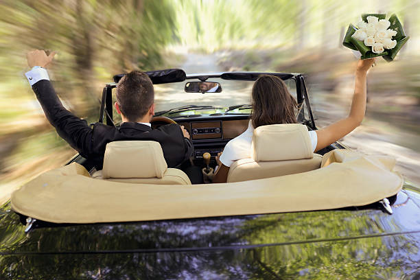 istock Just married couple in an old convertible car 186320039