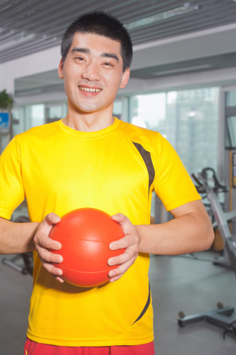 Yellow basketball ball on blue background. Horizontal composition.