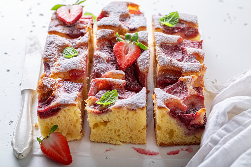 Homemade strawberry sponge cake with lemon and berries. Summer fruit jelly cake .