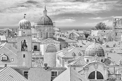Mediterranean cityscape in black-and-white color - view of the roofs of the Old Town of Dubrovnik with the Church of St. Blaise and the Assumption Cathedral, on the Adriatic coast of Croatia