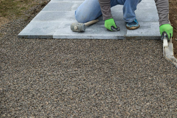 istock craftsman measures curbstone with folding rule while busy laying stone slabs for the walkway 1863223699