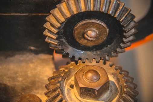 Old rusty gears fasten into themselves.