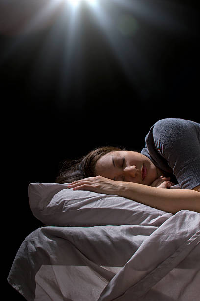 istock Creepy glowing orb hovering over a woman sleeping in bed 186323066
