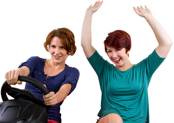 istock Two young female driving on a road trip -white background 186324371