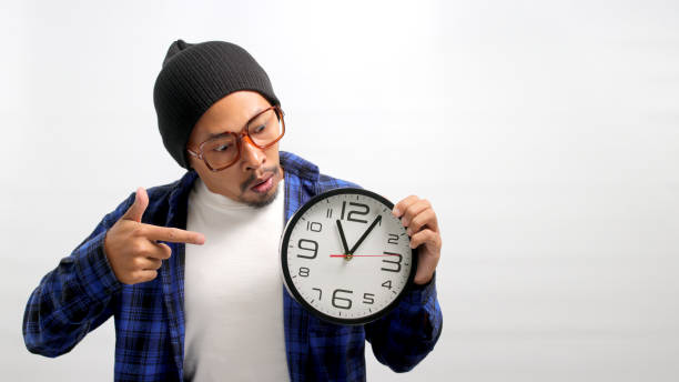 istock Surprised Asian man points to the clock 1863258260