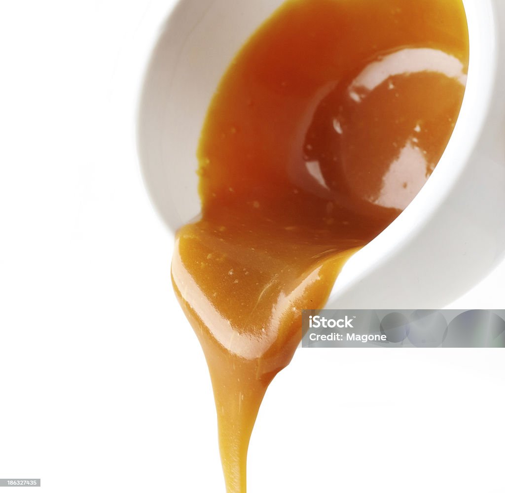 sweet caramel sauce sweet caramel sauce on a white background Bowl Stock Photo