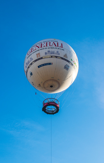Paris, France - 12 17 2023 : The Paris Generali Balloon, a tethered balloon, serving as a tourist attraction and air quality awareness tool in André Citroen Park