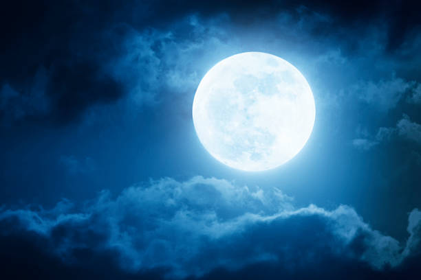 Dramatic Nighttime Sky and Clouds With Large Full Moon Dramatic photo illustration of a nighttime sky with brightly lit clouds and large, full, Blue Moon would make a great background. night sky only stock pictures, royalty-free photos & images