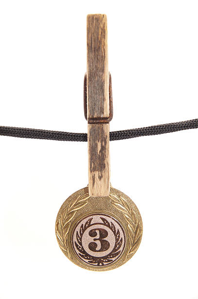 medal, clothespin and rope on a white background