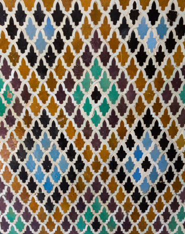 Oriental pattern mosaic of tiles in a mosque in Morocco forming diamond shapes