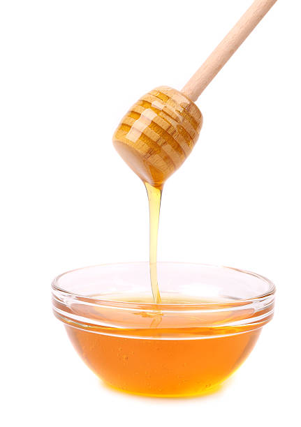 istock Bee honey with wooden dipper. 186332533