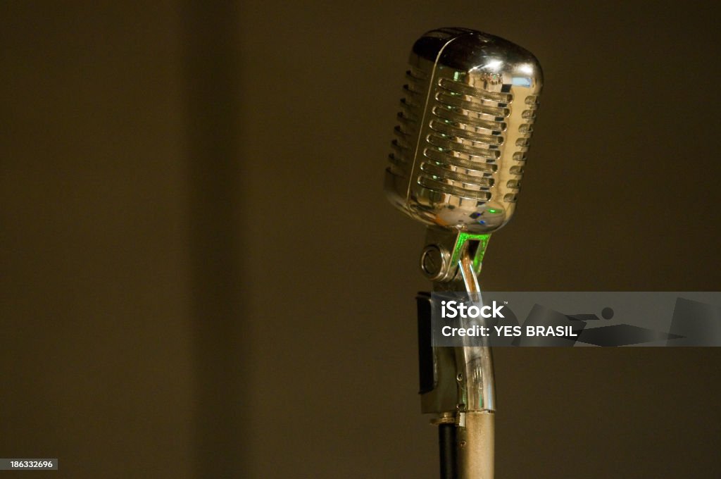 Microphone Close-Up Of An Old And Elegant Model Of A  Microphone. It's Shining With The Light From The Flash Of The Camera. Arts Culture and Entertainment Stock Photo