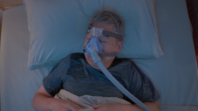 old man sleep with CPAP