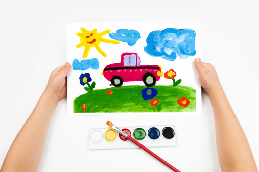 Child draws the car watercolors