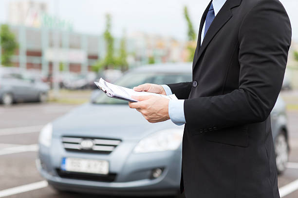 istock close up of man with car documents outside 186333992