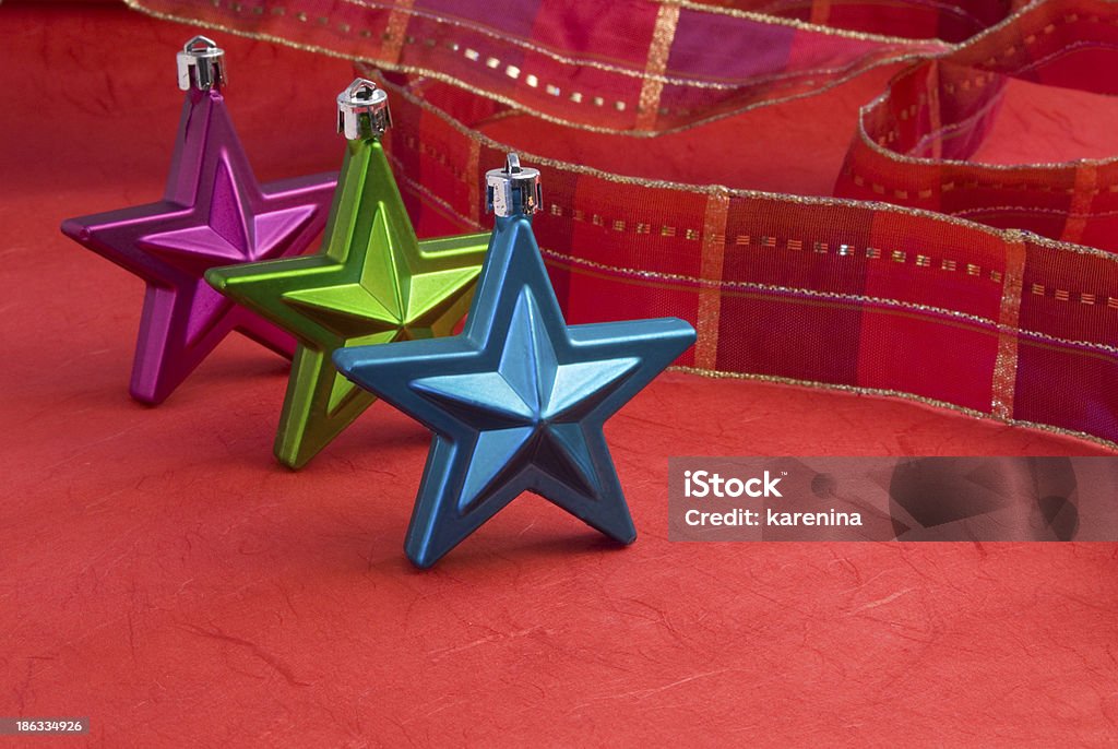 Ornaments Colorful christmas decoration on red background and red ribbon Blue Stock Photo