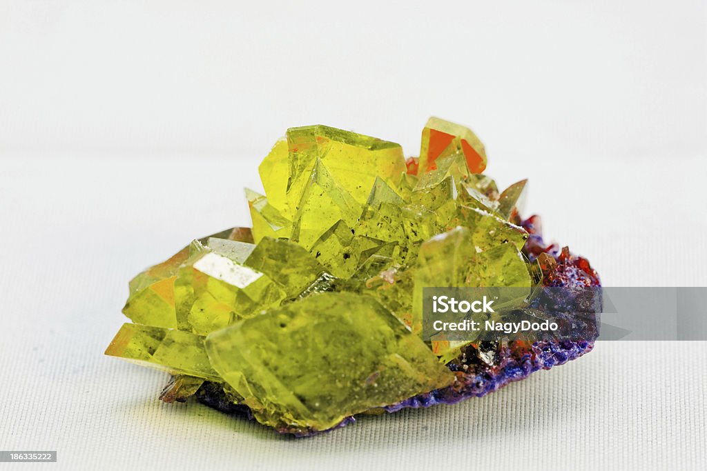crystal macro photo in topaz color Close up picture about a crystal with topaz color on white background (yellow crystal) Abstract Stock Photo