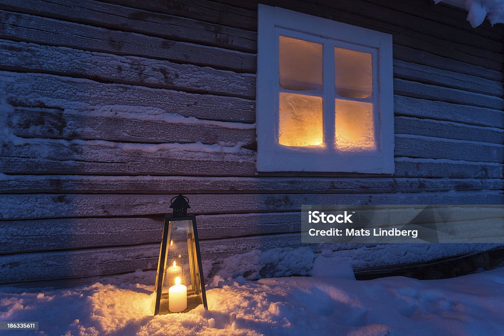 Lantern outside a cottage with frosty window Lantern on the outside a cottage standing in the snow with candle light shining through a frosty window, Gällivare, sweden Window Stock Photo