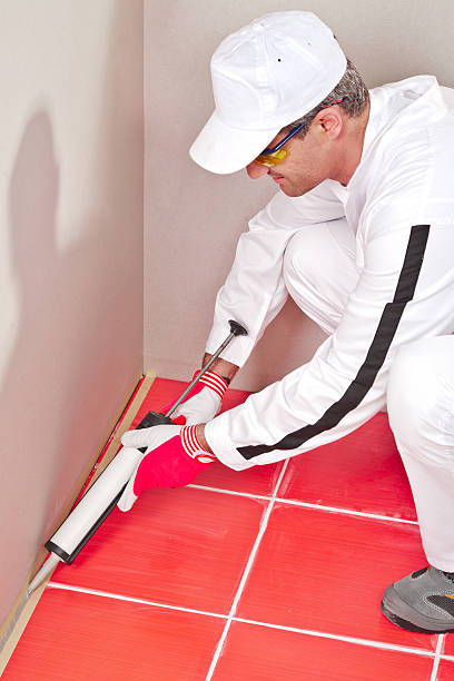 istock worker lays silicone sealant corner wall floor 186335810
