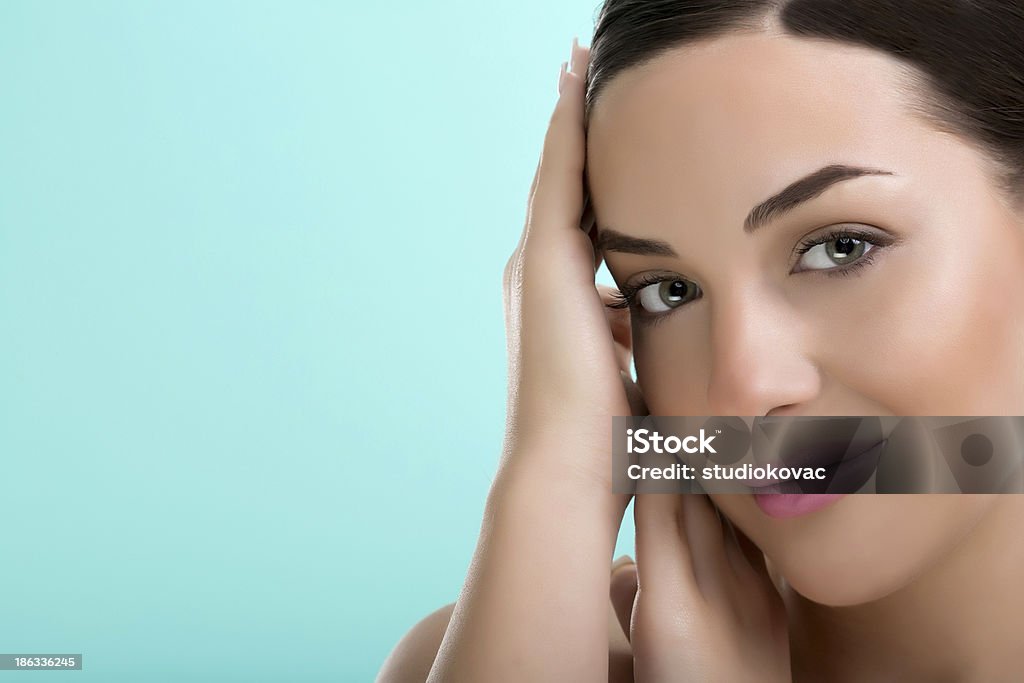 Portrait of young beautiful girl. Portrait of young beautiful girl on blue background. 18-19 Years Stock Photo