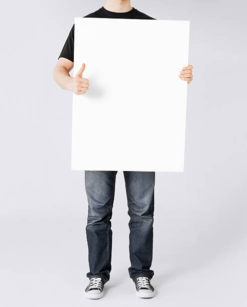 istock man showing white blank board and thumbs up 186337178