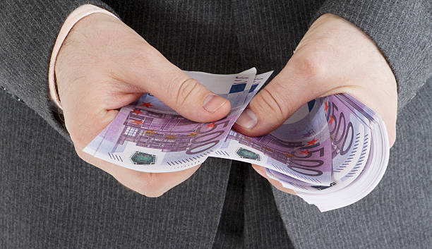 istock stack banknotes of 500 euro in male hands 186338002