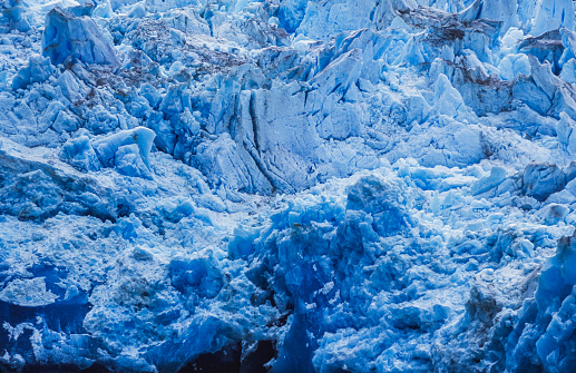 Close-up of an Alaskan glacier face, showing the crevices, fissures and cracks.\n\nTaken in Glacier Bay, Southeast Alaska, USA