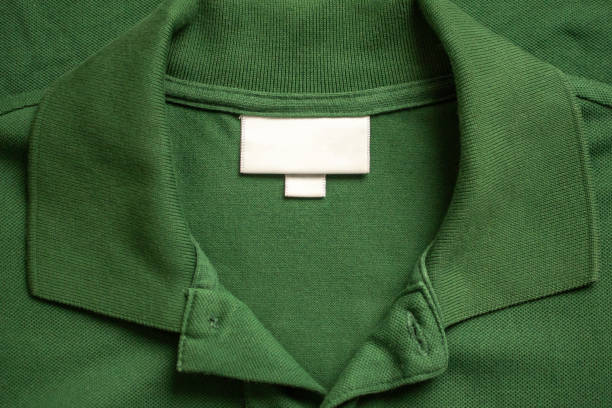 istock Blank white laundry care clothes label on green shirt fabric texture background 1863390957