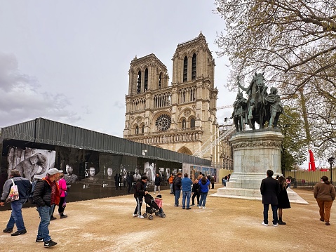 Paris, France - April 11 2023: visitors in front of the famous monument on the ile de la cite the Notre Dame cathedral