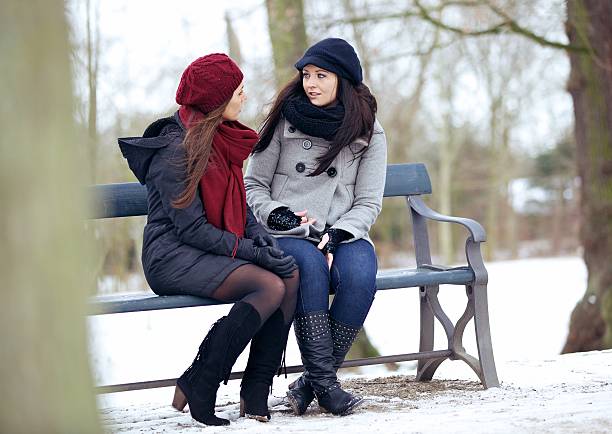 istock Bestfriends in  Serious Conversation while Sitting on a Bench 186344294