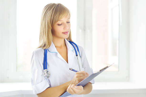 istock female doctor holding a notepad 186346772